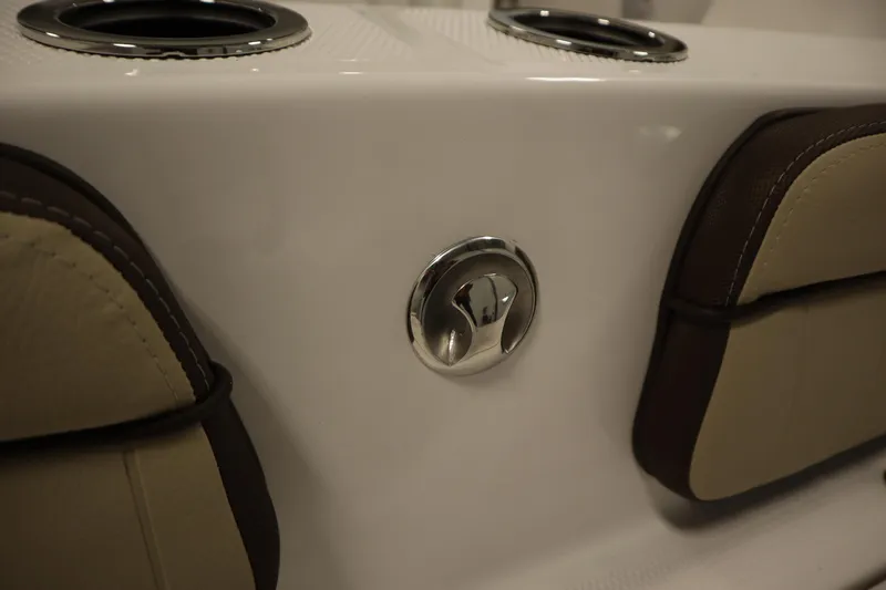 Slide: The Image of 2026 Yamaha Boats 222 FSH Sport interior detail with cup holders and seating. - 46