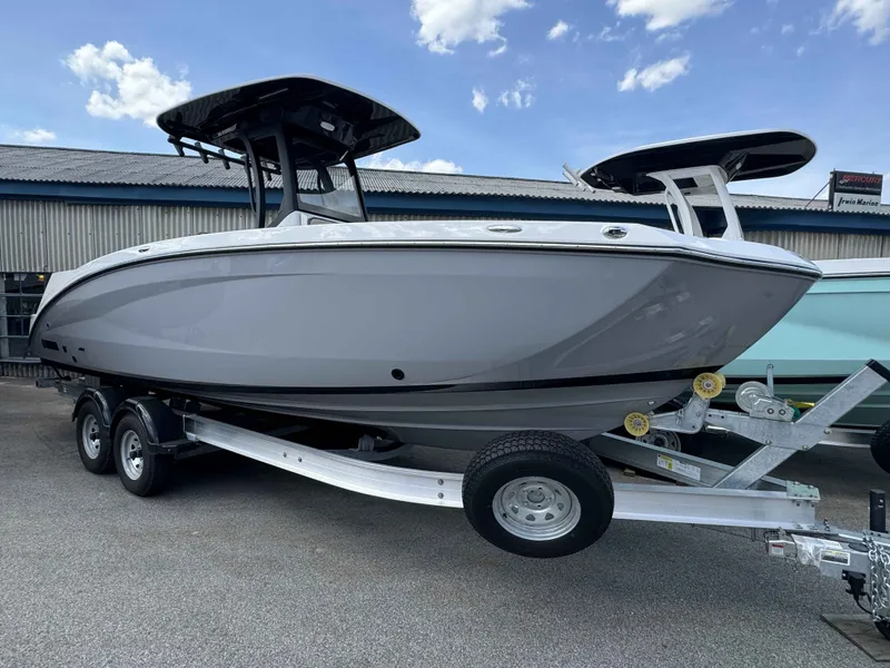 Slide: The Image of 2026 Yamaha Boats 255 FSH Sport H on trailer, side view. - 17