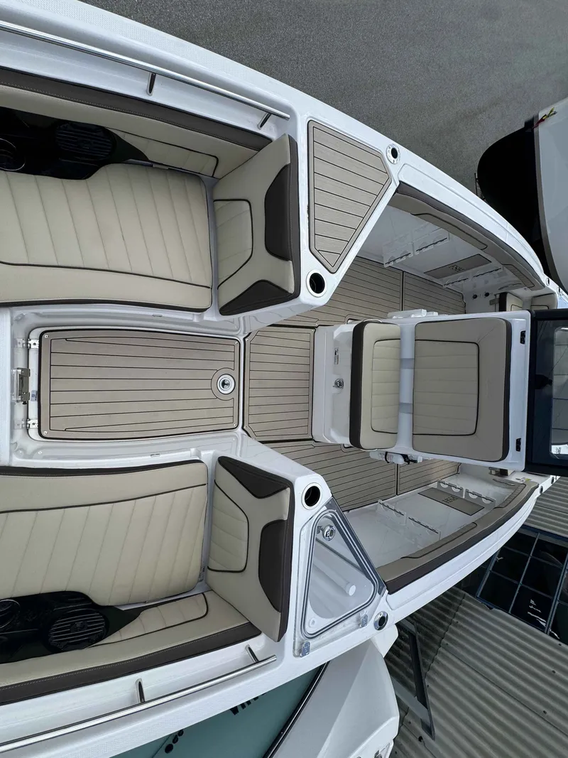 Slide: The Image of Interior view of 2026 Yamaha Boats 255 FSH Sport H with beige seating. - 33