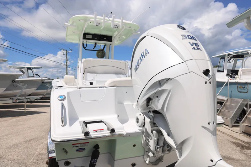 Slide: The Image of Interior of 2026 Sea Hunt Ultra 245 SE boat, featuring a compact marine toilet. - 11