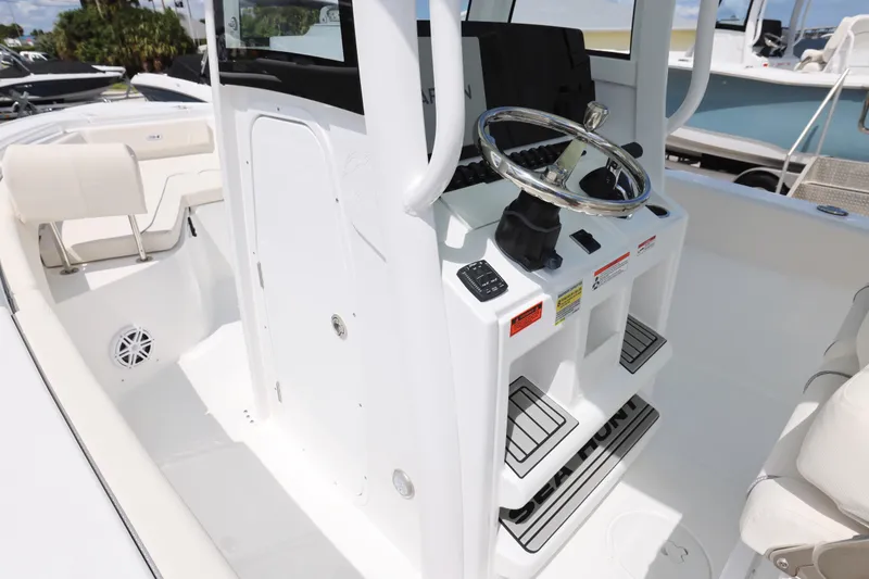 Slide: The Image of 2026 Sea Hunt Ultra 245 SE boat interior with seating and storage. - 13