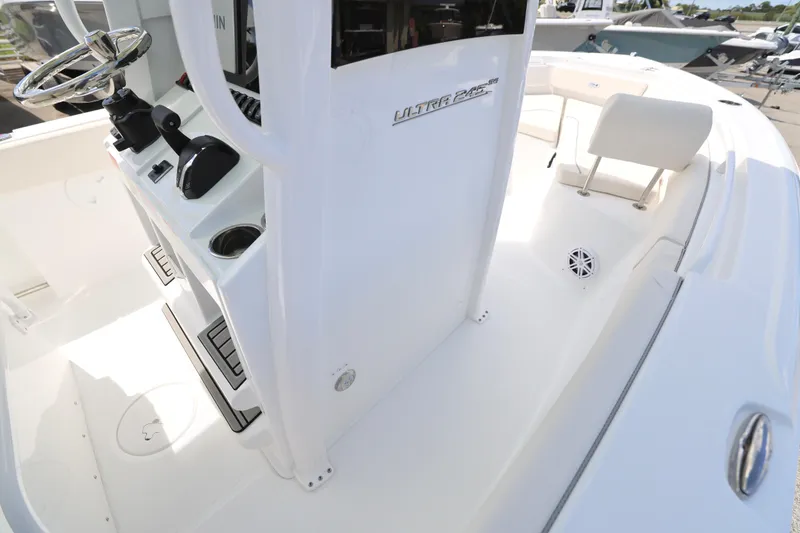 Slide: The Image of 2026 Sea Hunt Ultra 245 SE boat with Yamaha 300 V6 engine, docked under blue sky. - 14