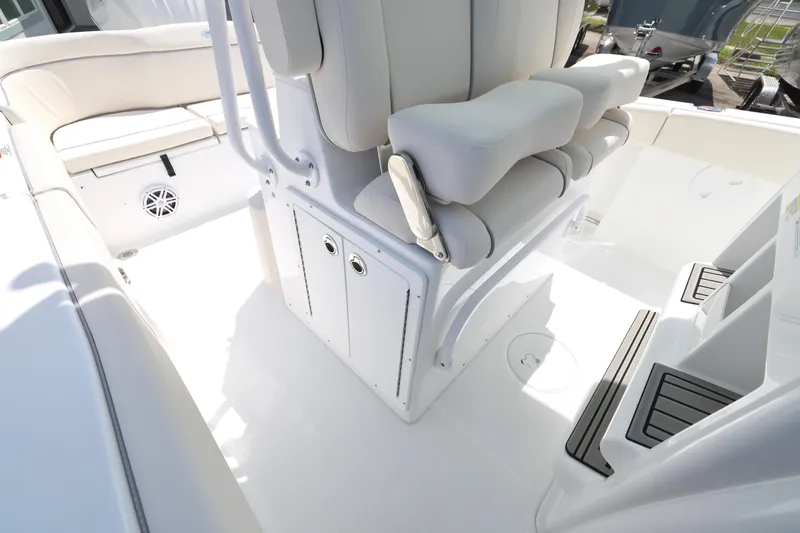 Slide: The Image of 2026 Sea Hunt Ultra 245 SE boat interior with seating and storage compartment. - 15