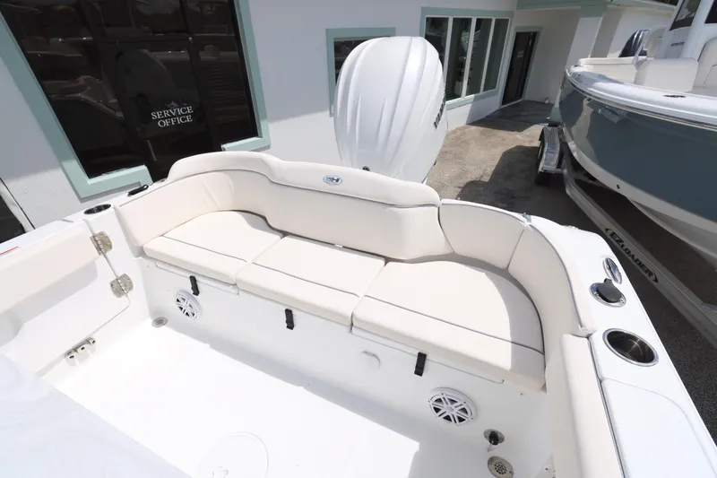 Slide: The Image of 2026 Sea Hunt Ultra 245 SE boat interior with cushioned seating and storage compartments. - 18