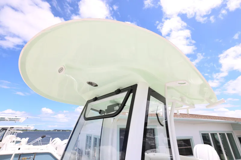 Slide: The Image of 2026 Sea Hunt Ultra 245 SE boat interior with cushioned seating and cup holders. - 20