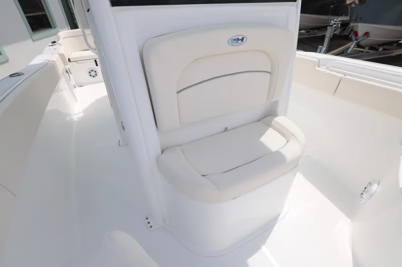 Slide: The Image of 2026 Sea Hunt Ultra 245 SE boat with sleek design under a clear blue sky. - 22