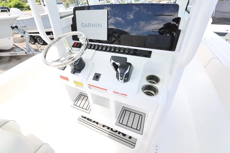 Slide: The Image of 2026 Sea Hunt Ultra 245 SE boat with powerful outboard motor on trailer. - 4