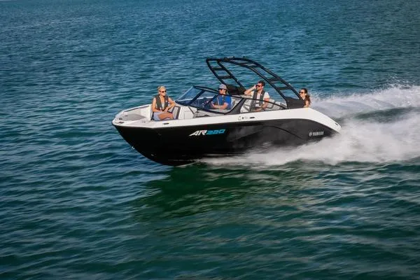 Slide: The Image of 2026 Yamaha Boats AR220 speeding on open water with passengers enjoying the ride. - 9