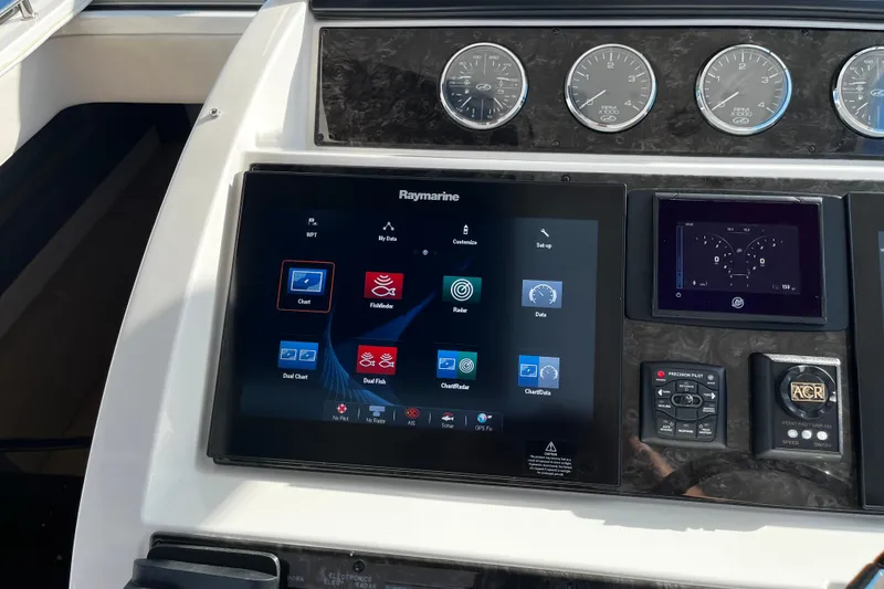 Slide: The Image of Dashboard of 2010 Sea Ray 450 Sundancer with Raymarine navigation system and gauges. - 13