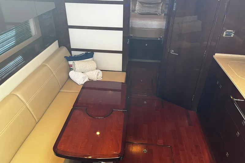 Slide: The Image of Luxurious interior of 2010 Sea Ray 450 Sundancer yacht with elegant seating and wooden finishes. - 19