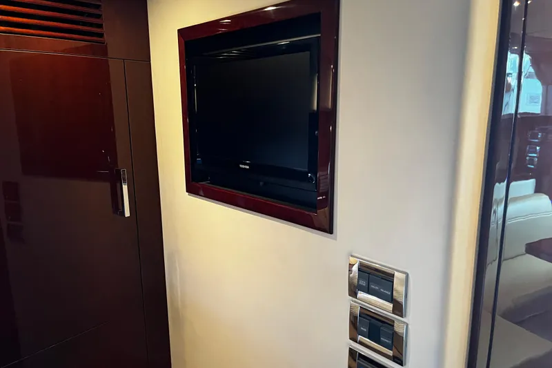 Slide: The Image of Wall-mounted TV in 2010 Sea Ray 450 Sundancer yacht interior. - 23