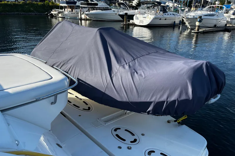 Slide: The Image of Covered Sea Ray 450 Sundancer boat, 2010 model, docked in a marina. - 3