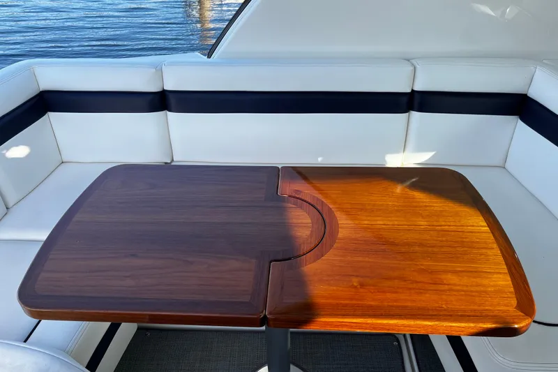 Slide: The Image of Luxury seating area on 2010 Sea Ray 450 Sundancer yacht with wooden table. - 7