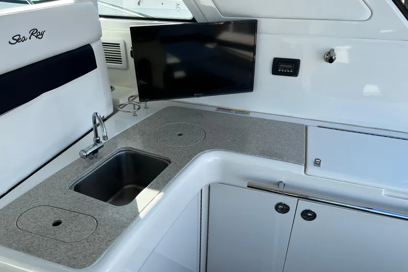 Slide: The Image of Interior of 2010 Sea Ray 450 Sundancer yacht with sink, countertop, and mounted TV. - 8