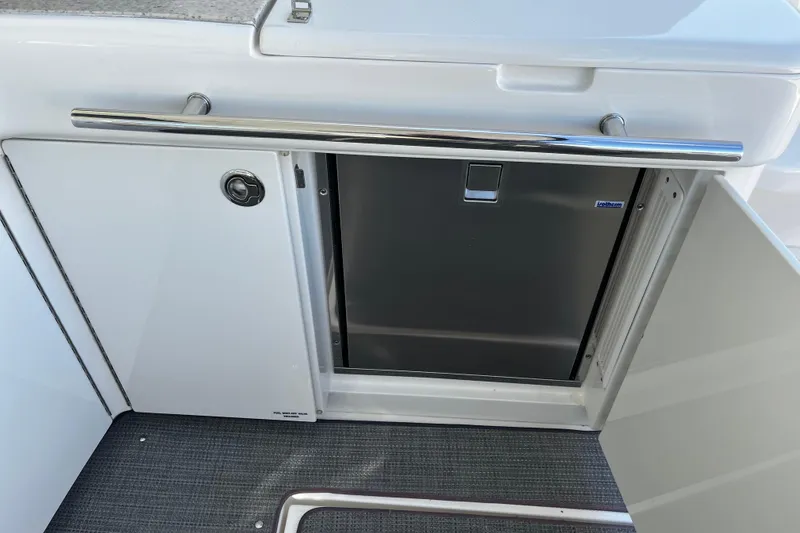 Slide: The Image of 2010 Sea Ray 450 Sundancer yacht interior with stainless steel fridge and storage. - 9