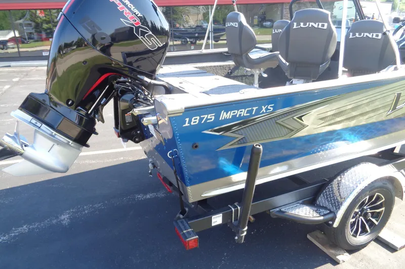 Slide: The Image of 2026 Lund 1875 Impact XS Sport boat with Mercury Pro XS engine, parked on trailer. - 11
