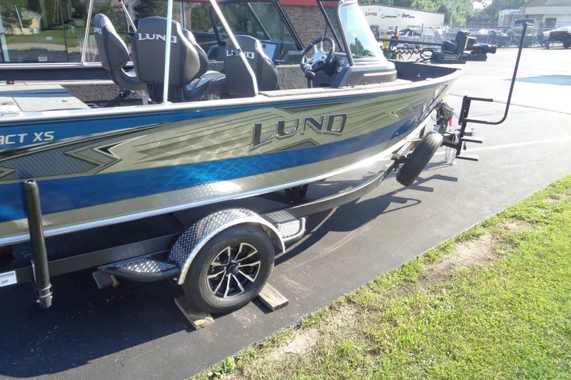 Slide: The Image of 2026 Lund 1875 Impact XS Sport boat on trailer, parked outdoors. - 12