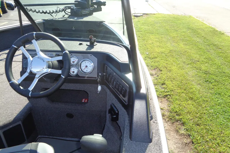 Slide: The Image of Interior view of 2026 Lund 1875 Impact XS Sport boat dashboard and steering wheel. - 14