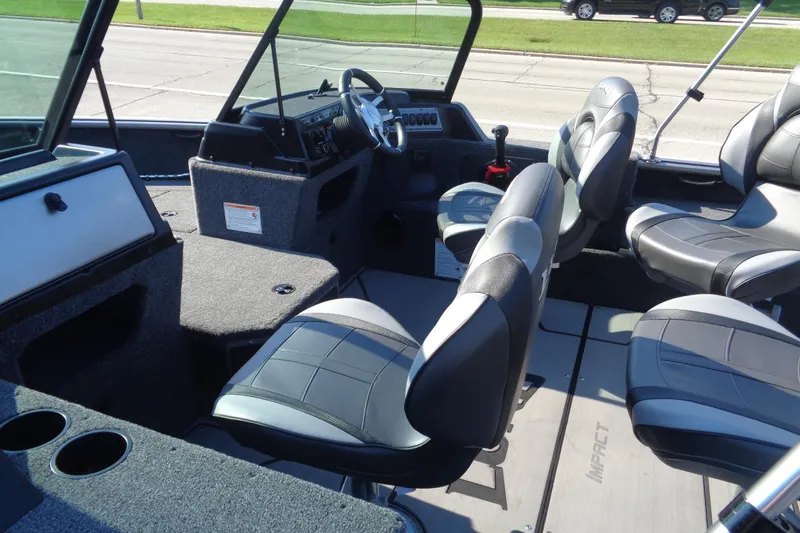 Slide: The Image of 2026 Lund 1875 Impact XS Sport boat interior with modern seating and dashboard. - 18