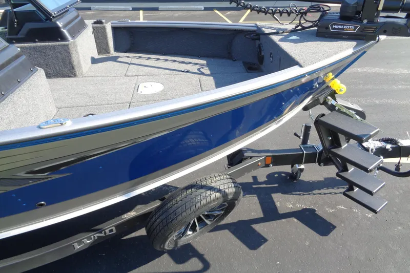 Slide: The Image of 2026 Lund 1875 Impact XS Sport boat on trailer, blue exterior, Minn Kota motor. - 9