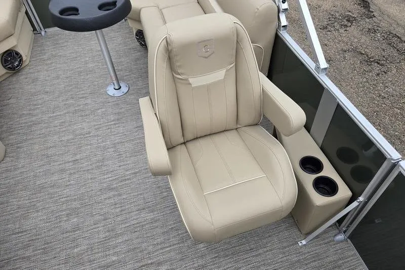 Slide: The Image of 2026 Godfrey Xperience 2286 SBX boat interior with beige seating and cup holders. - 11