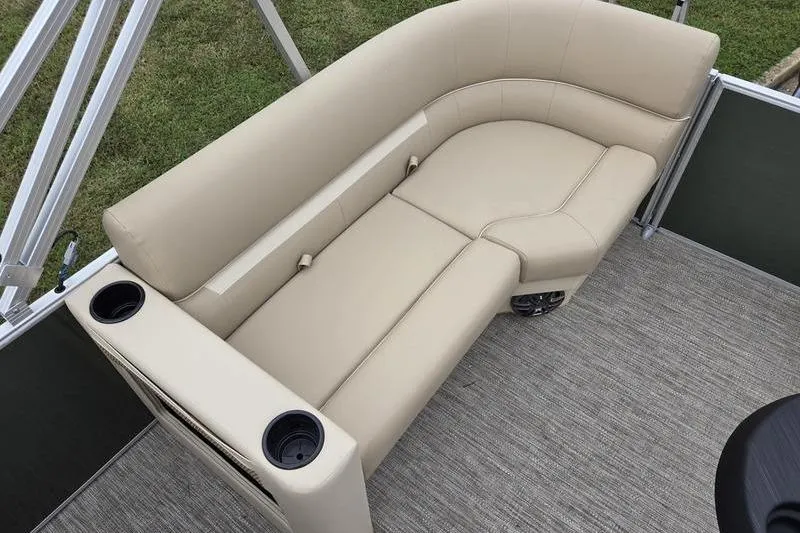 Slide: The Image of Beige seating on 2026 Godfrey Xperience 2286 SBX pontoon boat, featuring cup holders and carpeted flooring. - 12