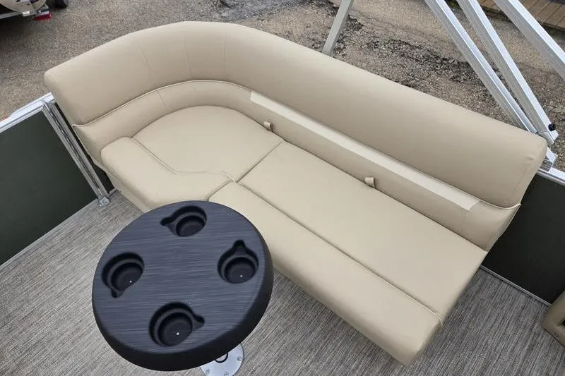Slide: The Image of 2026 Godfrey Xperience 2286 SBX boat interior with beige seating and round table. - 14
