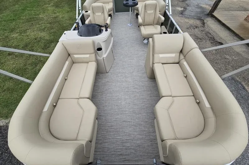 Slide: The Image of 2026 Godfrey Xperience 2286 SBX pontoon boat interior with beige seating and helm station. - 3