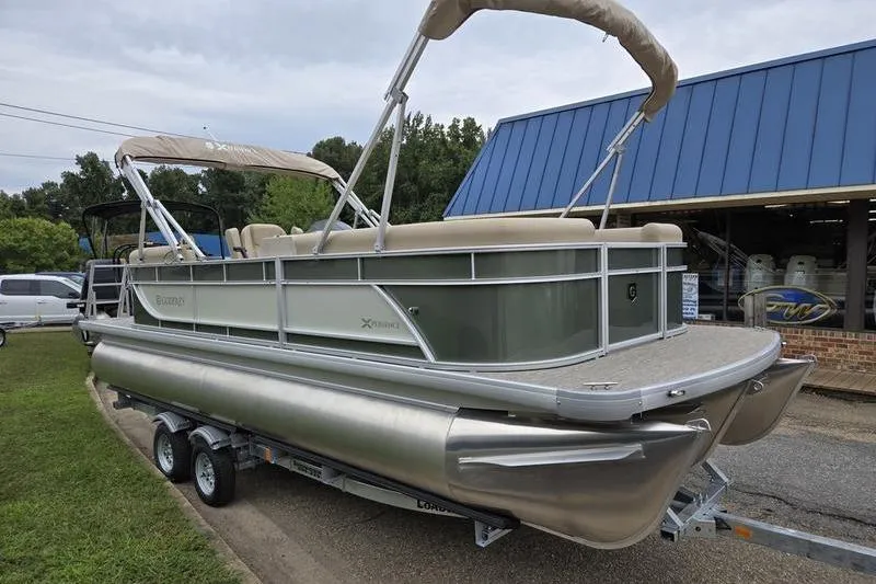 Slide: The Image of 2026 Godfrey Xperience 2286 SBX pontoon boat on trailer, parked outdoors. - 5