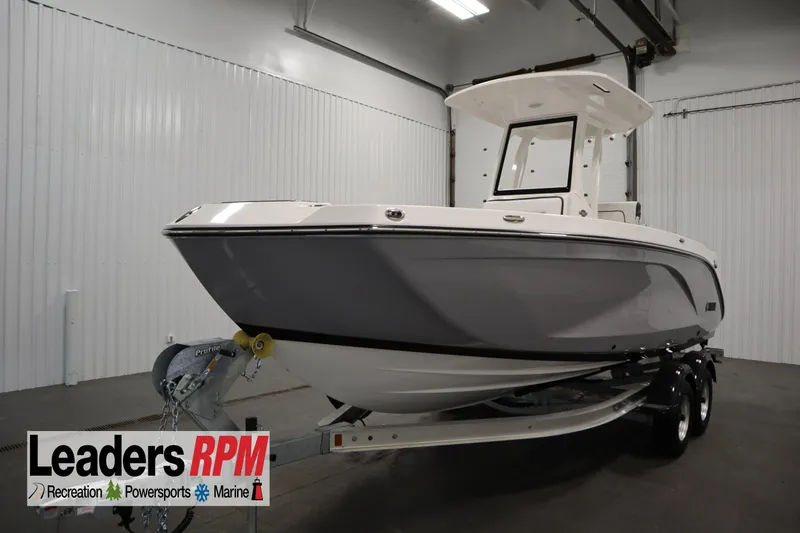 The Image of 2026 Yamaha Boats 222 FSH Sport E in showroom, on trailer, side view. - 0