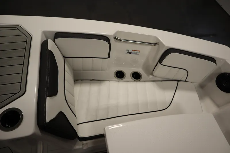 Slide: The Image of 2026 Yamaha Boats 222 FSH Sport E interior seating, featuring white and black cushioned design. - 13