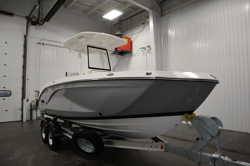 Slide: The Image of 2026 Yamaha Boats 222 FSH Sport E in a showroom, on a trailer. - 2