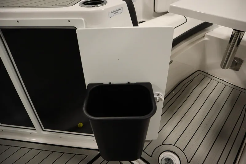 Slide: The Image of Yamaha Boats 2026 222 FSH Sport E interior with trash bin and sleek flooring. - 21