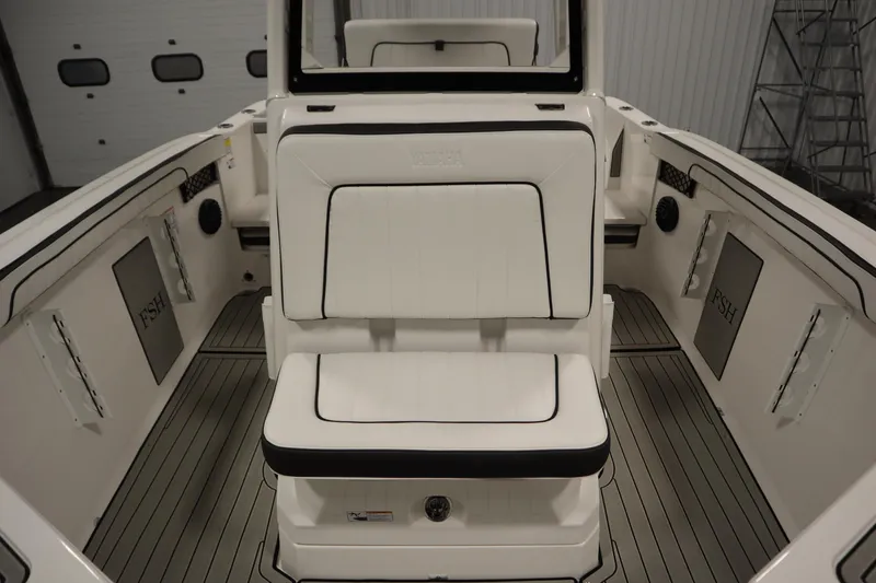 Slide: The Image of 2026 Yamaha Boats 222 FSH Sport E interior with white seating and sleek design. - 25