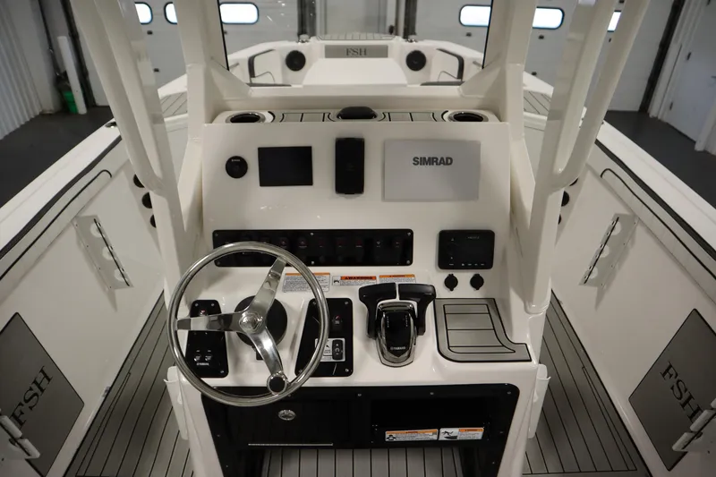 Slide: The Image of 2026 Yamaha Boats 222 FSH Sport E dashboard with steering wheel and controls in a sleek design. - 29