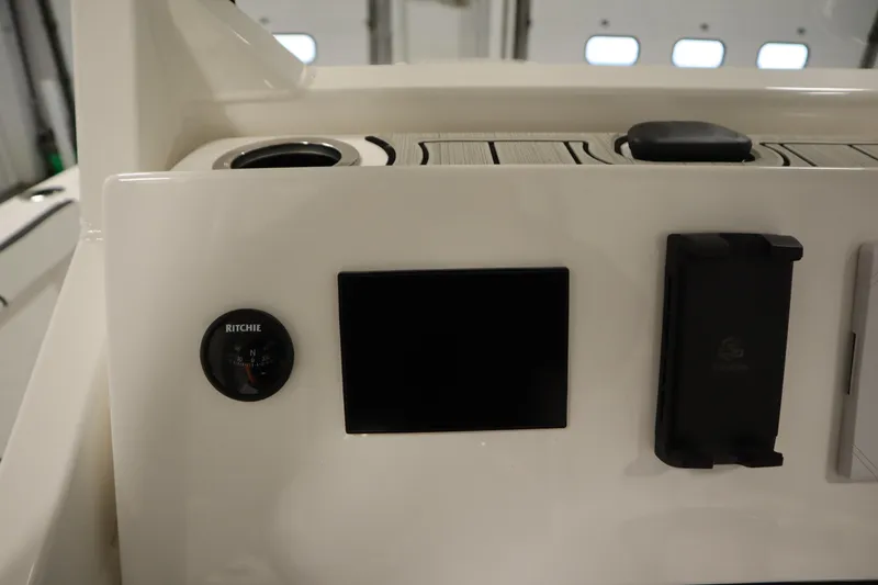 Slide: The Image of Control panel of 2026 Yamaha Boats 222 FSH Sport E with compass and display. - 31