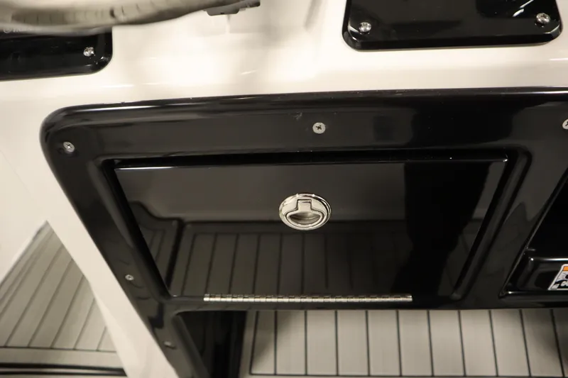 Slide: The Image of 2026 Yamaha Boats 222 FSH Sport E storage compartment with sleek black finish. - 37