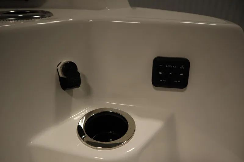 Slide: The Image of Yamaha 222 FSH Sport E 2026 boat console with control panel and cup holder. - 49