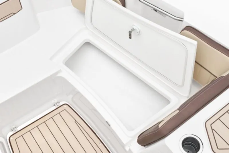 Slide: The Image of 2026 Yamaha Boats 222 FSH Sport E interior storage compartment with cushioned seating. - 55