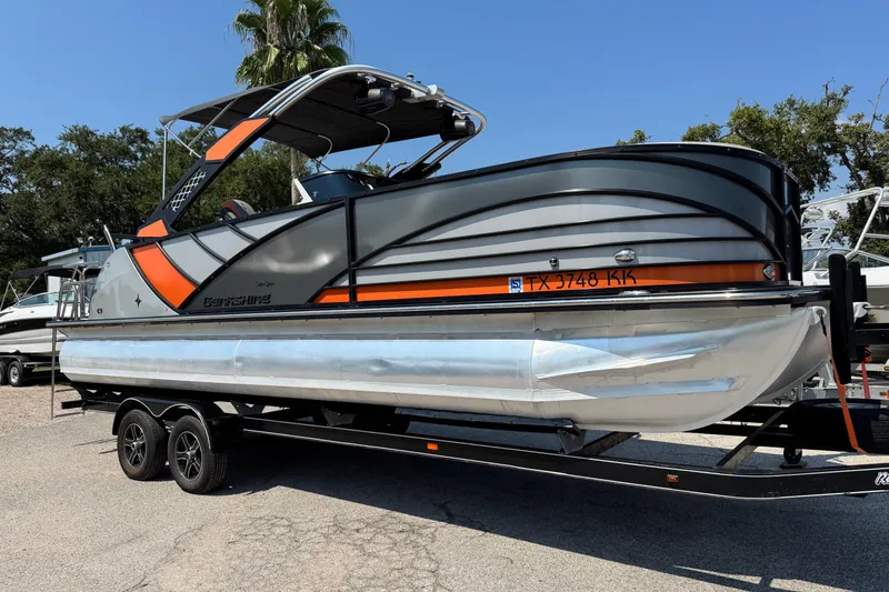 The Image of 2021 Berkshire 250 Super-Sport Premium pontoon boat on trailer, parked outdoors. - 0