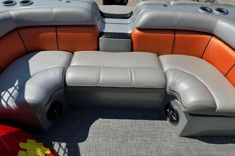 Slide: The Image of Luxurious seating in 2021 Berkshire 250 Super-Sport Premium boat, featuring gray and orange upholstery. - 17