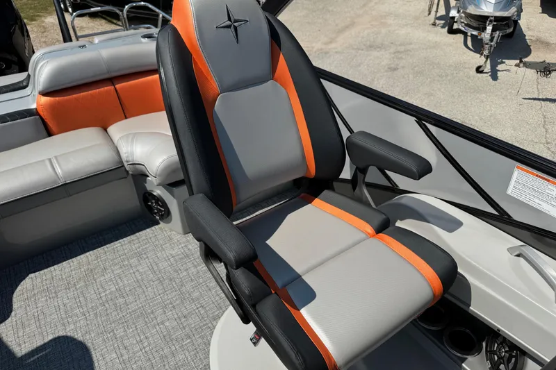 Slide: The Image of Captain's chair in 2021 Berkshire 250 Super-Sport Premium boat, featuring orange and gray upholstery. - 20
