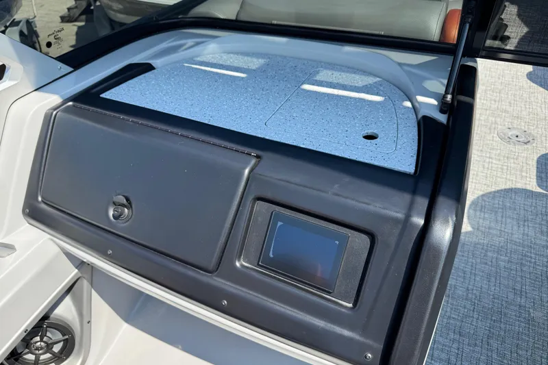 Slide: The Image of 2021 Berkshire 250 Super-Sport Premium dashboard with touchscreen and storage compartment. - 26