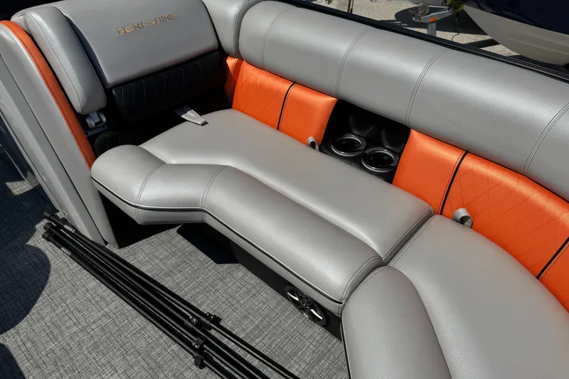 Slide: The Image of Luxurious seating in 2021 Berkshire 250 Super-Sport Premium boat with orange accents and cup holders. - 30