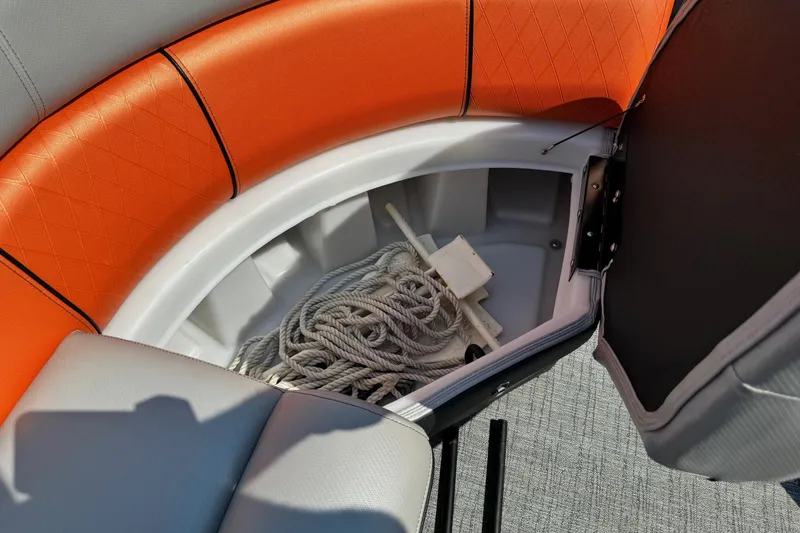 Slide: The Image of 2021 Berkshire 250 Super-Sport Premium boat storage compartment with orange seating and rope. - 33
