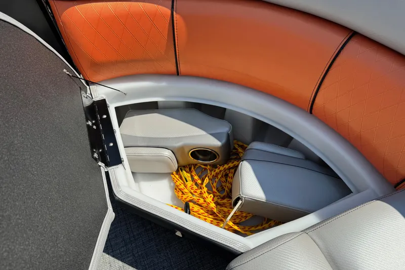 Slide: The Image of 2021 Berkshire 250 Super-Sport Premium boat interior storage with orange and gray seating. - 34