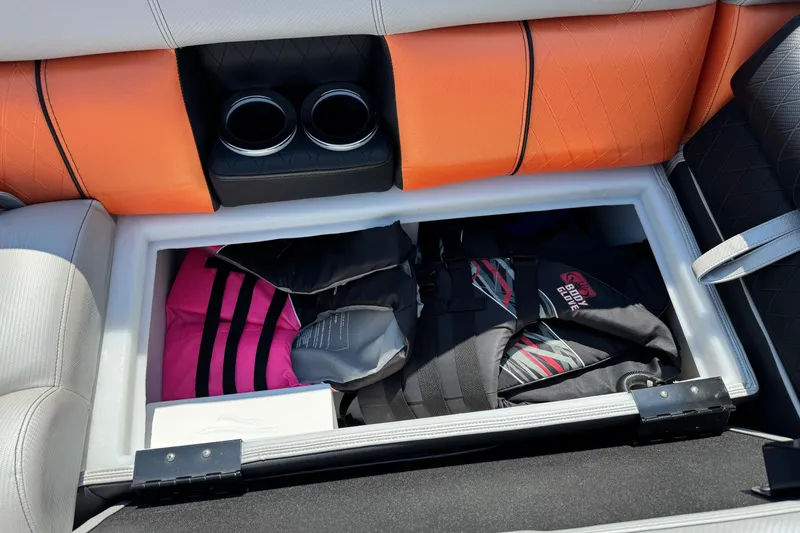 Slide: The Image of 2021 Berkshire 250 Super-Sport Premium boat storage with life jackets and cup holders. - 35