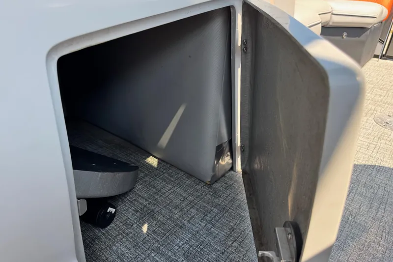 Slide: The Image of Open storage compartment on 2021 Berkshire 250 Super-Sport Premium boat, featuring gray interior. - 38