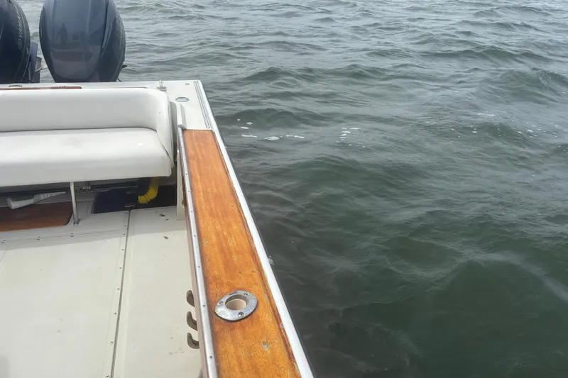 Slide: The Image of 1988 Boston Whaler 25 Outrage boat with dual engines on water. - 10