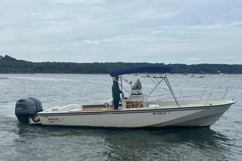 Slide: The Image of 1988 Boston Whaler 25 Outrage boat with Yamaha engine on calm water. - 3